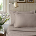 Alhambra clay brown 300 thread count cotton jacquard sateen sheet set styled on a bed