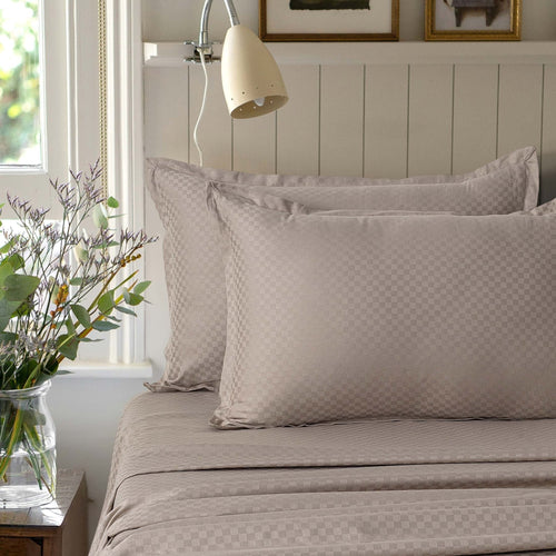 Alhambra clay brown 300 thread count cotton jacquard sateen sheet set styled on a bed