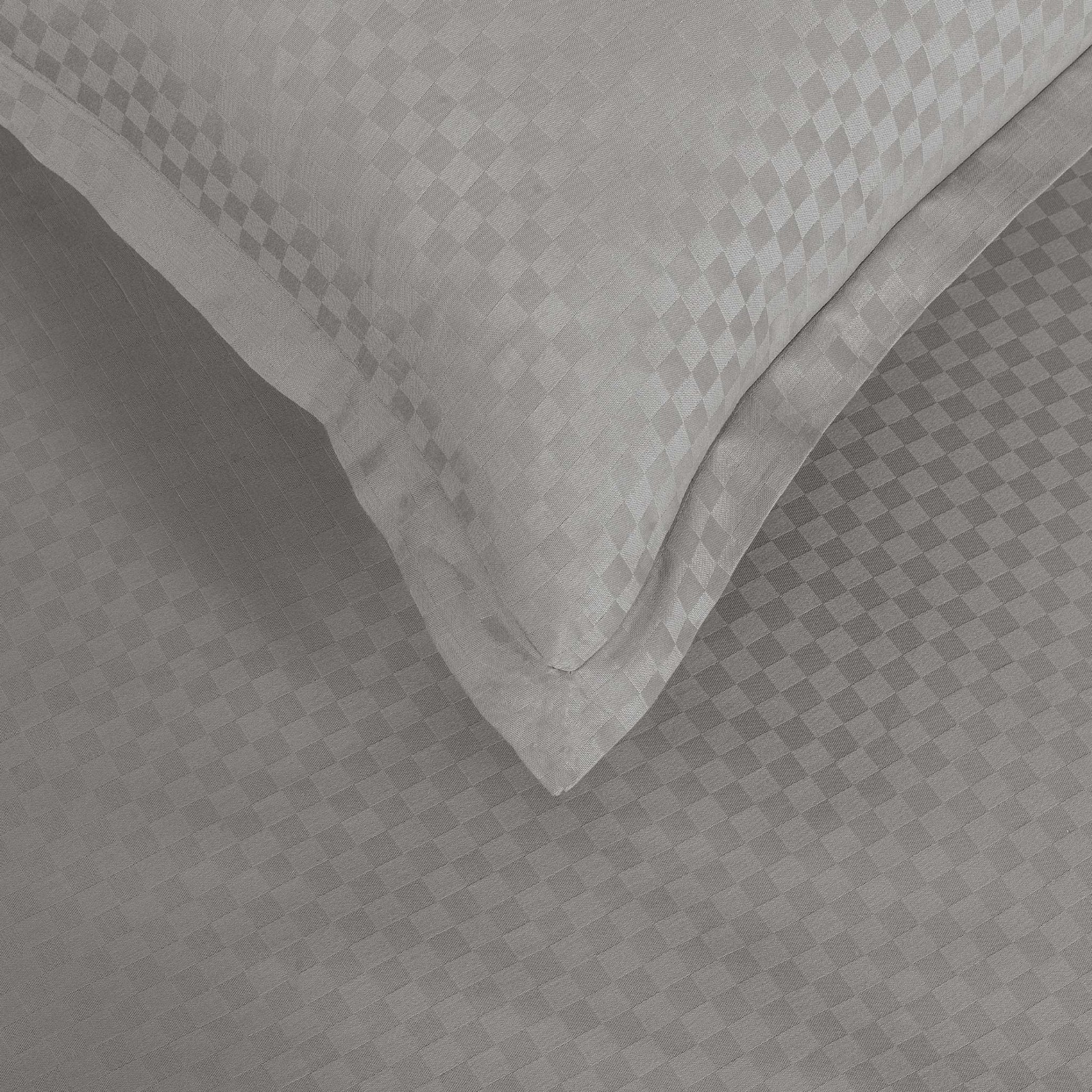 Close-up of Alhambra stone grey Oxford pillowcase with jacquard checkerboard weave