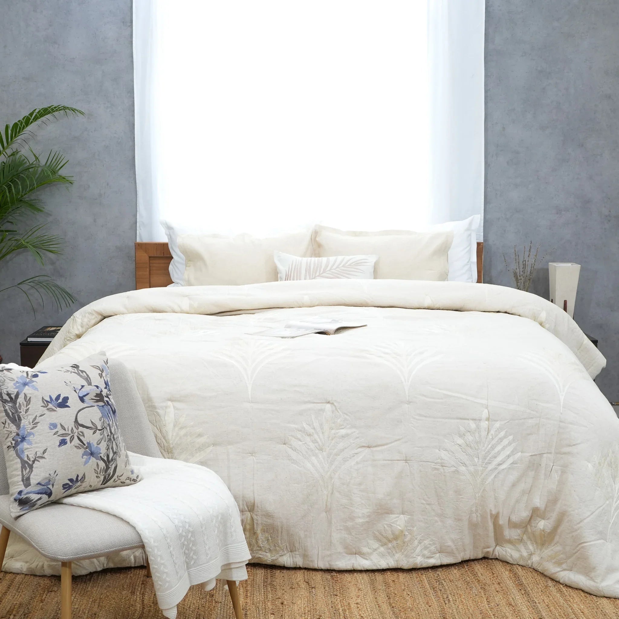 Full bed styled with natural embroidered cotton-linen quilt and matching pillows