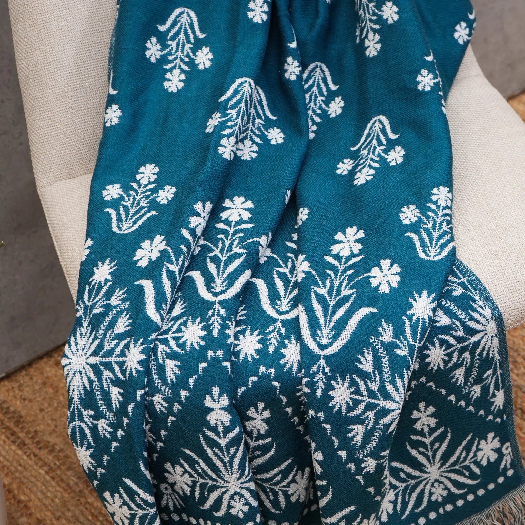 Close-up of blue jacquard floral throw with woven floral pattern