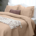Serenity Champagne Kantha silk quilt styled on a bed with matching cushions