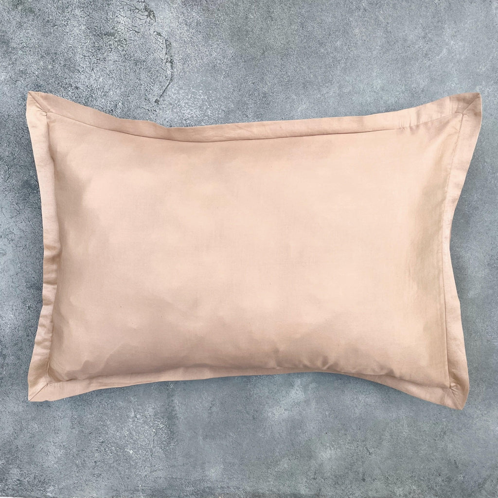 Matching Champagne silk cushion cover on grey textured background