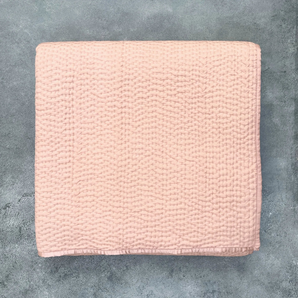 Flat lay of Rose Gold Kantha silk quilt showing hand quilted texture