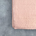 Folded Rose Gold Kantha silk quilt highlighting Kantha stitching