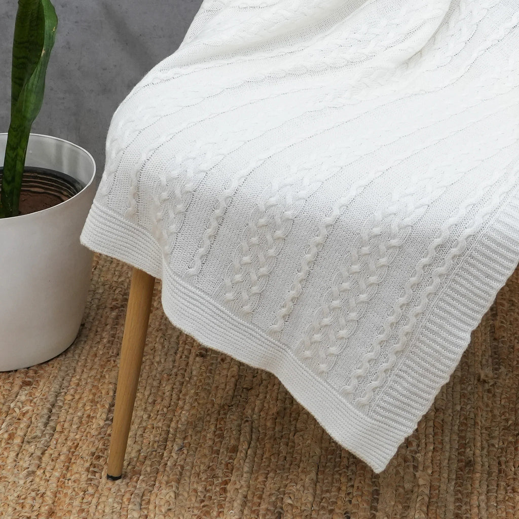 Ivory cotton cable knit throw showing textured knit pattern