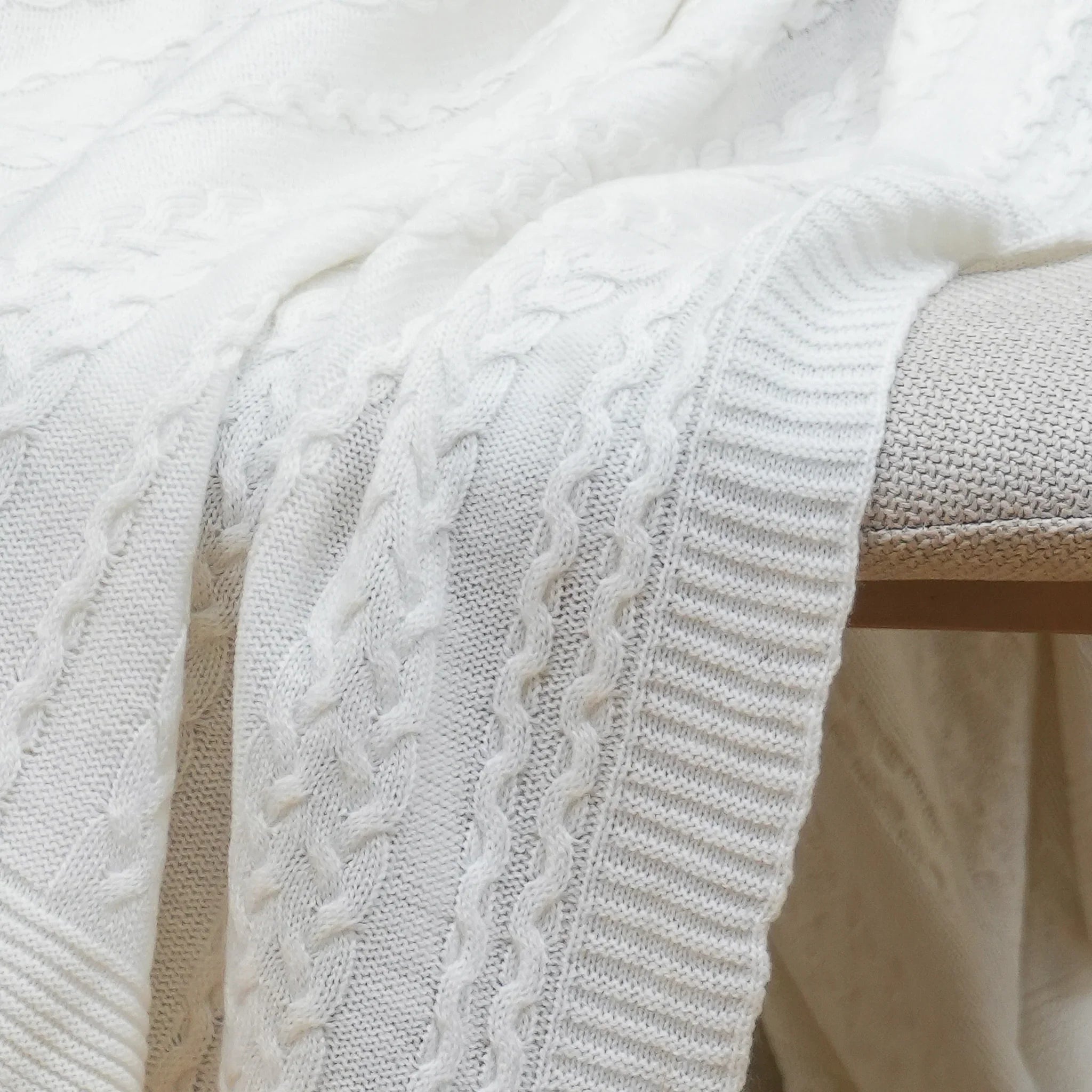 Close-up of ivory cotton cable knit throw texture