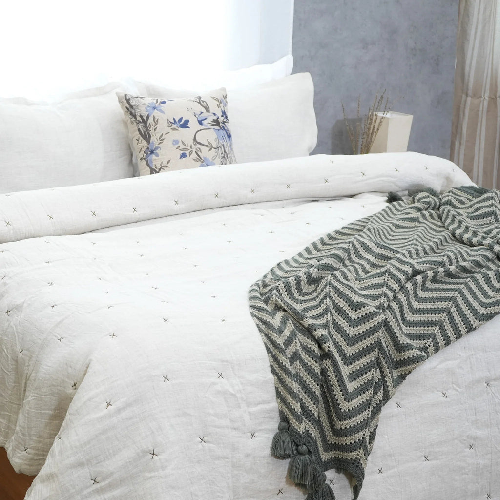 Natural ivory chambray pure linen quilt with star quilting styled on a bed