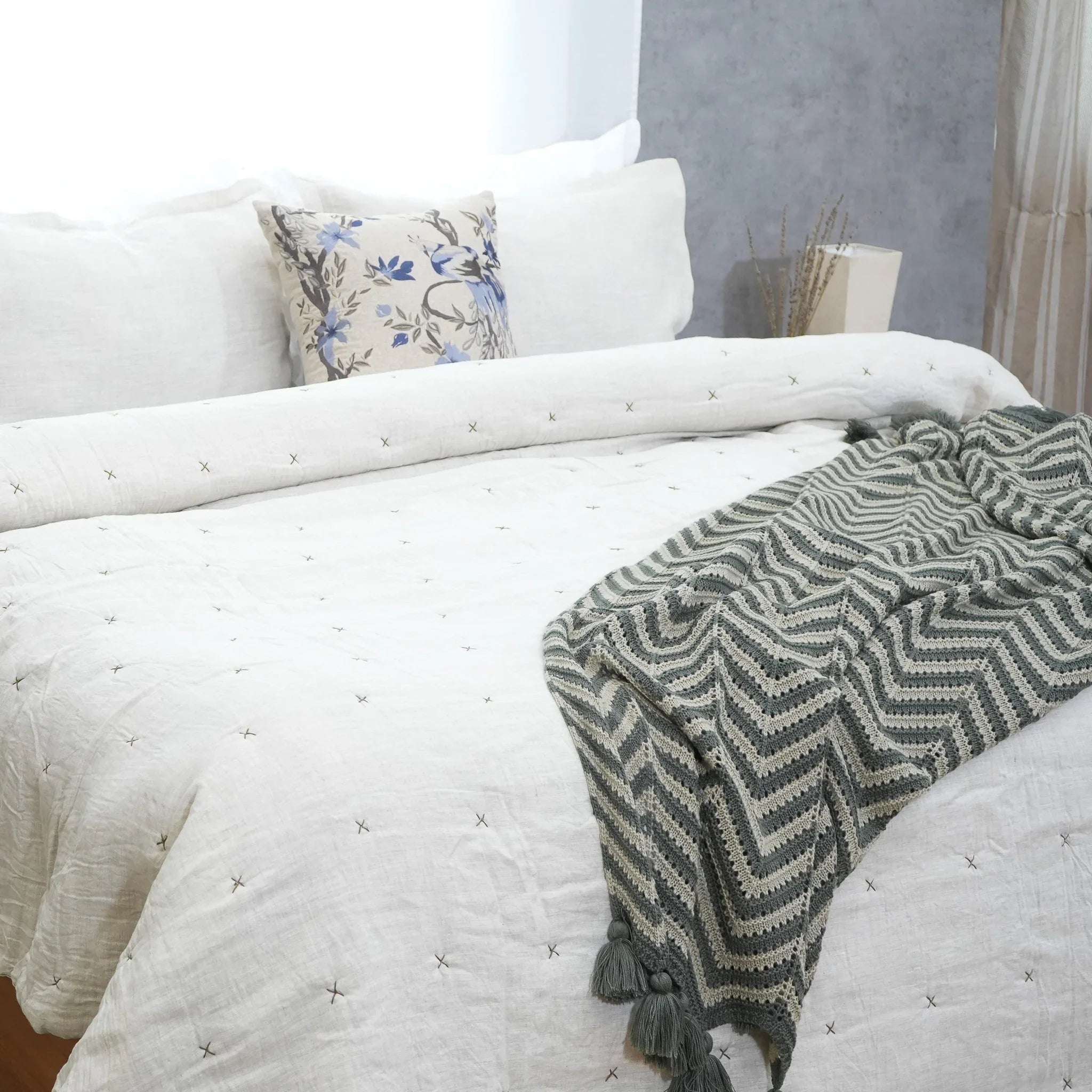 Natural ivory chambray pure linen quilt with star quilting styled on a bed