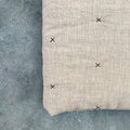 Close-up of natural ivory chambray pure linen quilt with stitched star detail