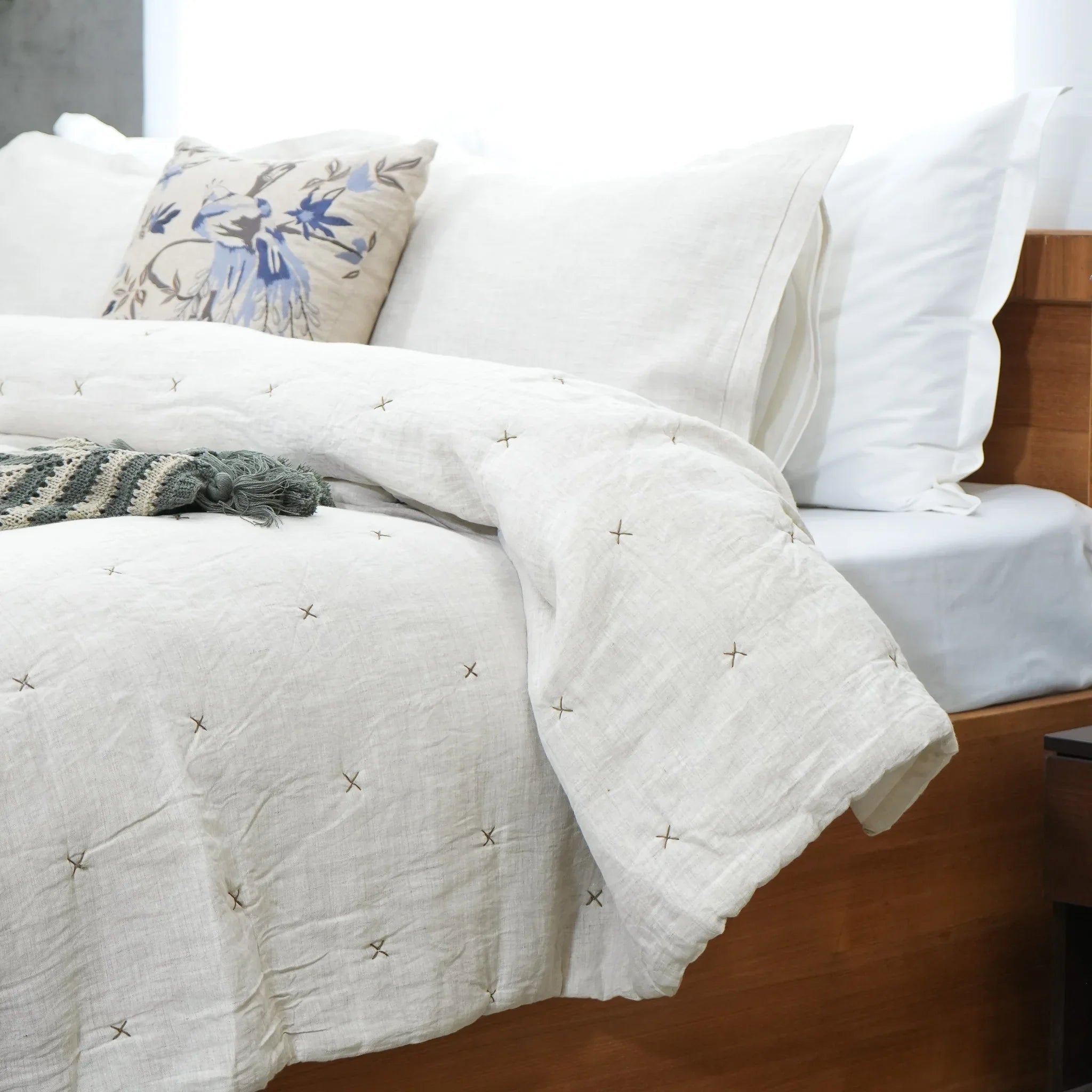 Close-up of natural ivory chambray pure linen quilt with stitched star pattern