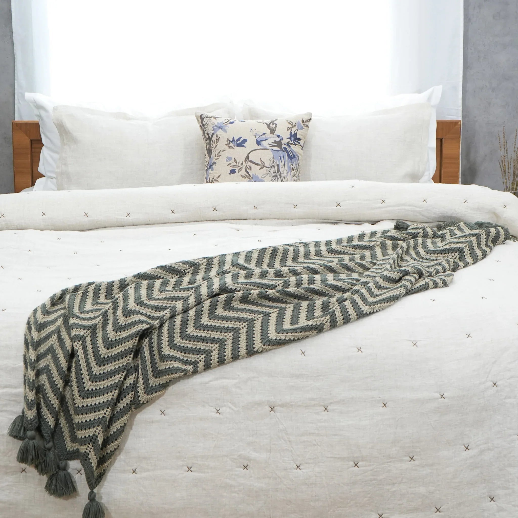 Natural ivory chambray pure linen quilt folded at the foot of a bed