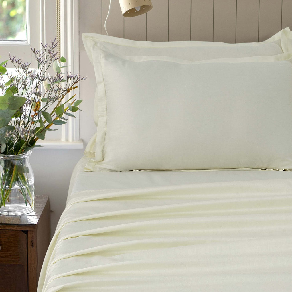 Verona ivory mist 300 thread count cotton sateen sheet set styled on a bed