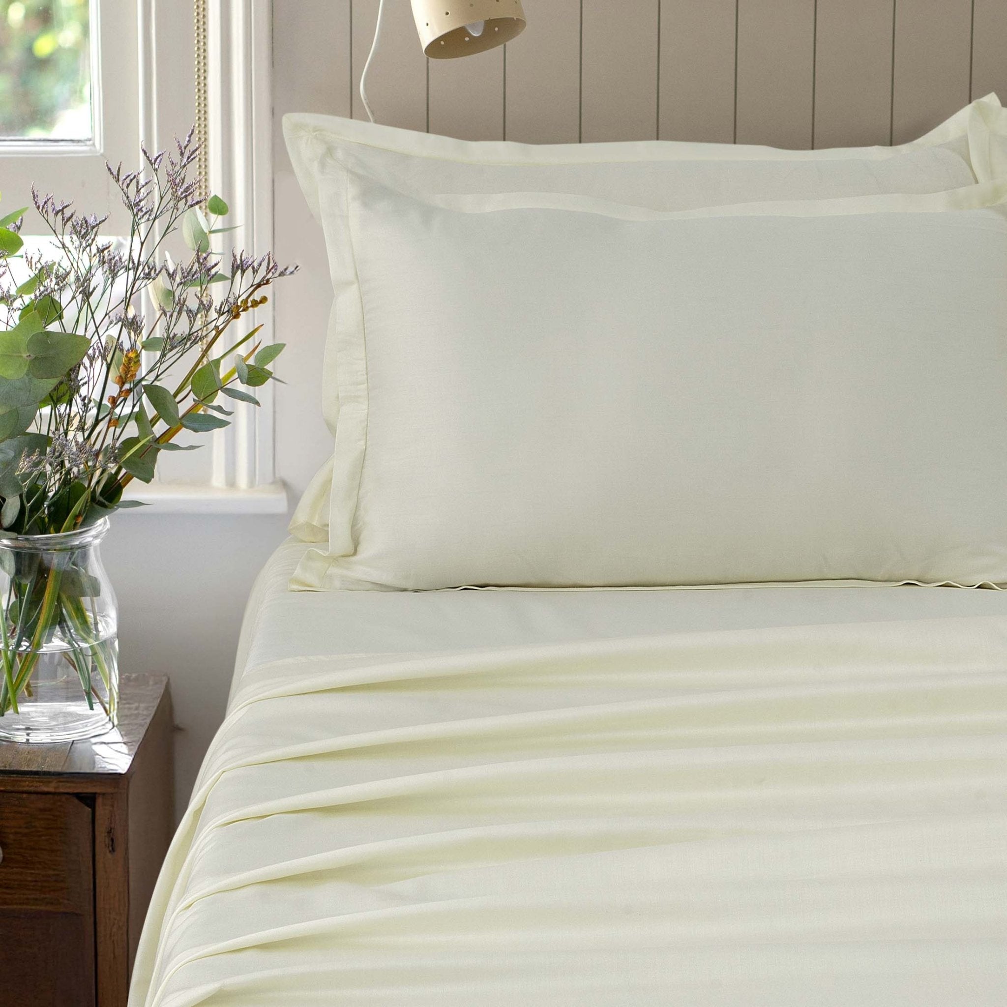 Verona ivory mist 300 thread count cotton sateen sheet set styled on a bed