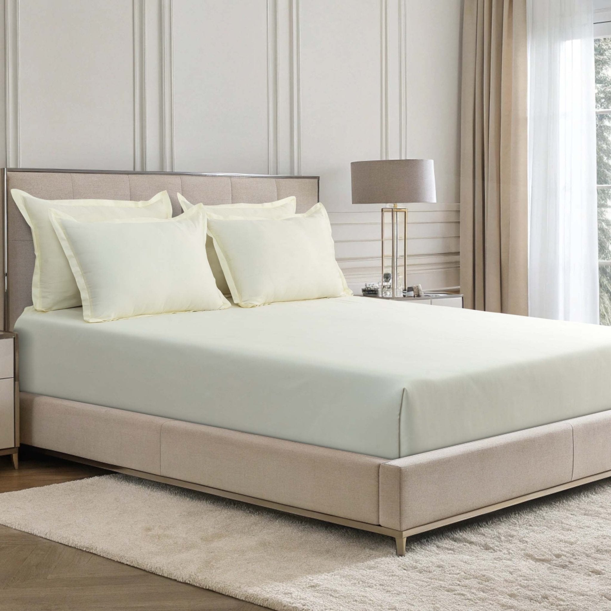 Verona ivory mist 300 thread count cotton sateen sheet set styled on a bed with matching pillowcases